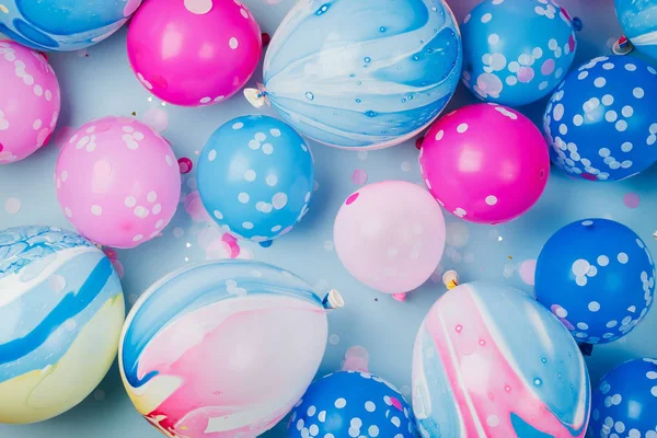 Colorful balloons on pastel colored background