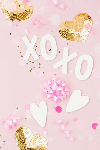 pink and golden decorations with xoxo lettering