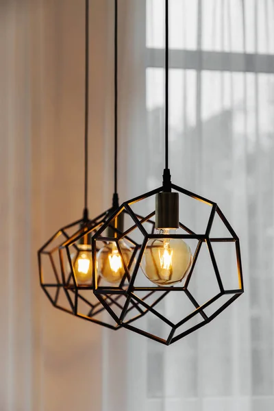 Lamp in modern style with Edison's light bulb. Warm tone light bulb lamp. Stylish interior.