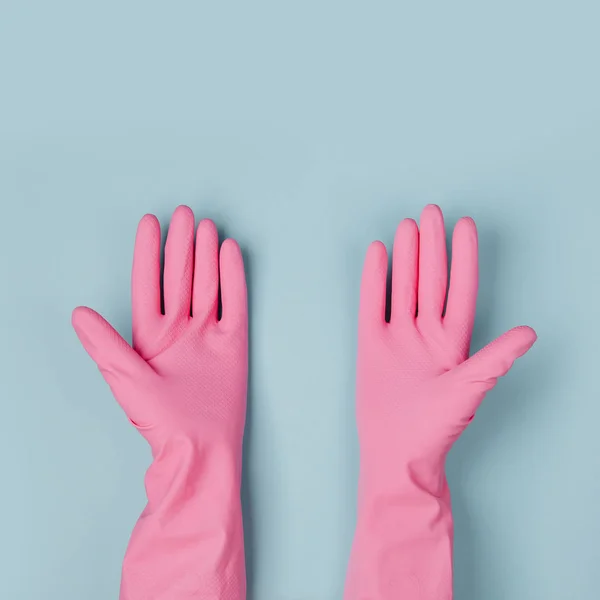 Female hands cleaning on blue background. Cleaning or housekeeping concept background. Copy space.  Flat lay, Top view.