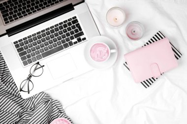 Laptop ve kahveyle yatakta çalışma alanı. Sabah konsepti. Düz yatıyordu 