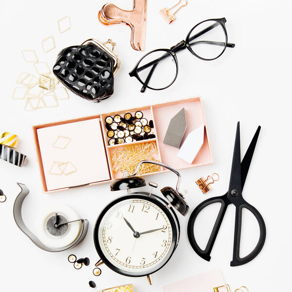 Flat lay stylish set: alarm clock, washi tape,  paper clips, note on white background. Flat lay, top view. Business Stationery concept.