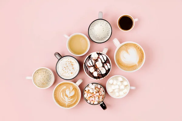 Various kinds of coffee in cups of different size   on pale pink background.  Coffee  Time concept.  Flat lay, top view