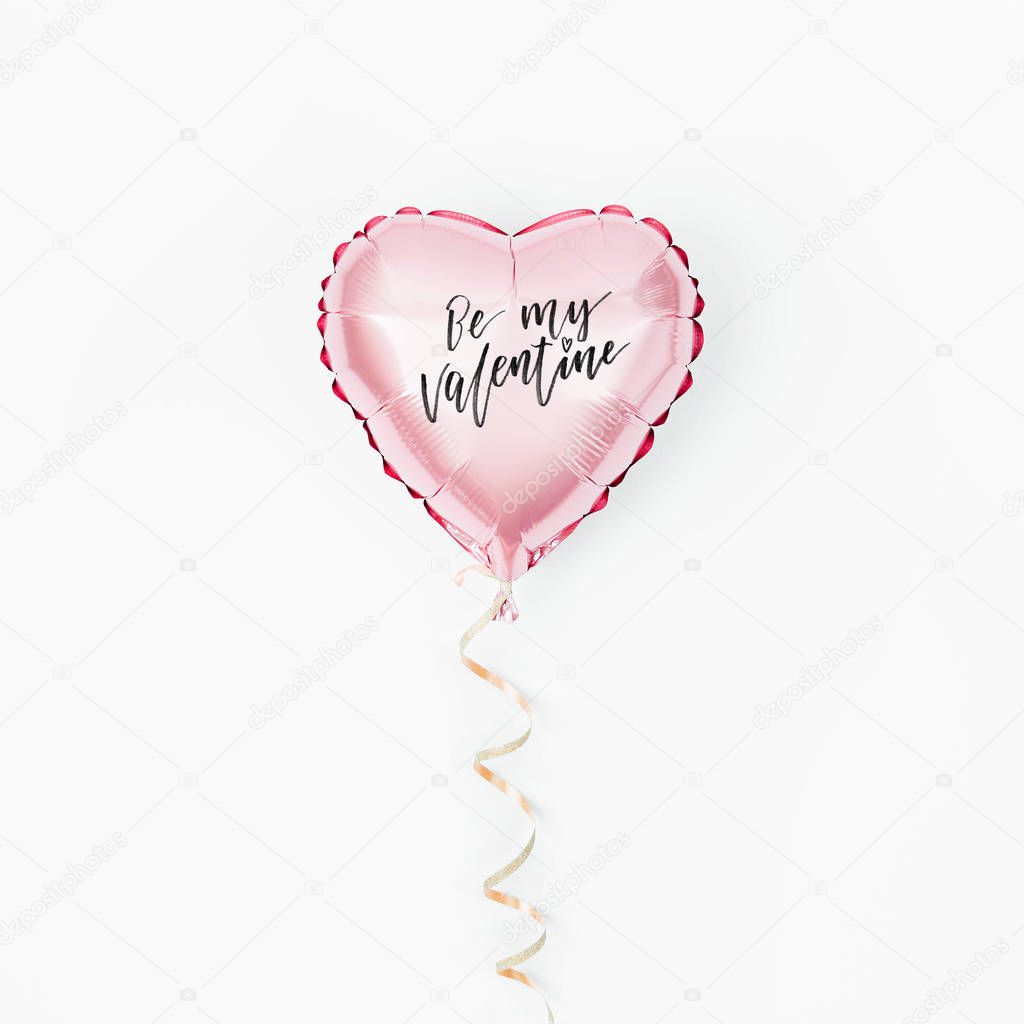 Single Balloon of heart shaped foil on white background. Love concept. Holiday celebration. Valentine's Day or wedding/bachelorette party decoration. Metallic balloon