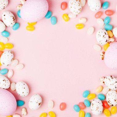 Şık çerçeve şeker çikolata yumurta ve jelibon, pembe arka plan yapılmış