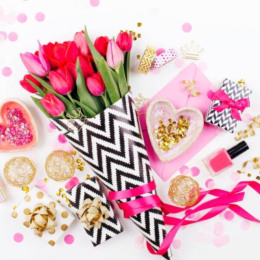 Siyah ve beyaz şık ambalaj kağıdı, hediyeler, kozmetik ve beyaz zemin üzerine konfeti ile kadın aksesuarları pembe laleler