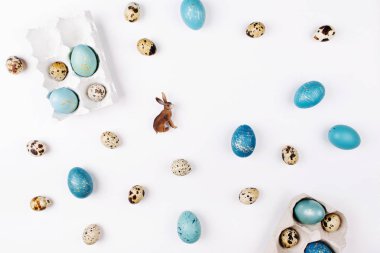 Paskalya tatil yaratıcı arka plan ile bıldırcın ve mavi Paskalya yumurtaları, tavşan ve kopya alanı ile 