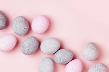 Soluk pembe ve gri Paskalya yumurtaları şık arka plan. Boyalı Paskalya yumurtaları. Düz yatıyordu 