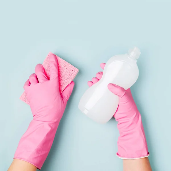 Female hands cleaning on blue background. Cleaning or housekeeping concept background. Copy space.  Flat lay, Top view.