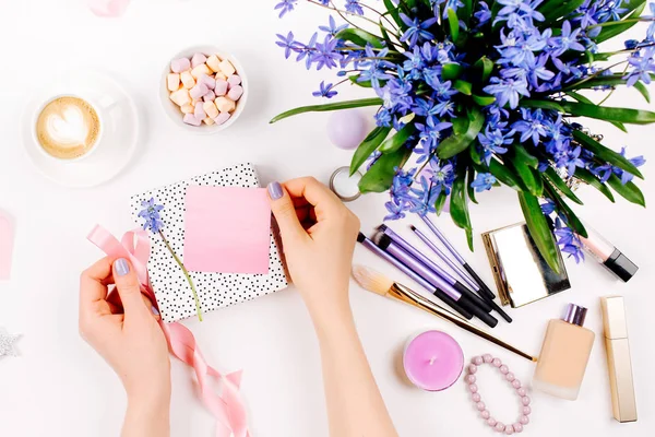 Woman Unpacks Gift Background Blue Spring Bouquet Coffee Cup Candies — Stock Photo, Image