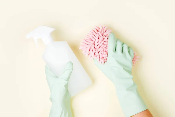 Female hands cleaning on yellow background, housekeeping concept background