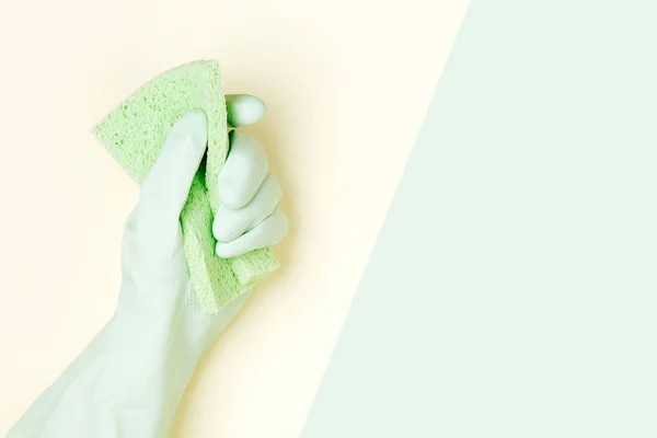 Female hand cleaning on yellow and green background, housekeeping concept background