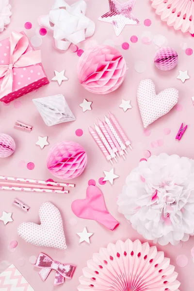 Pink and white Paper Decorations, pom-pom, candy, hearts, gifts, confetti for Baby party. Birthday concept.  Flat lay, top view