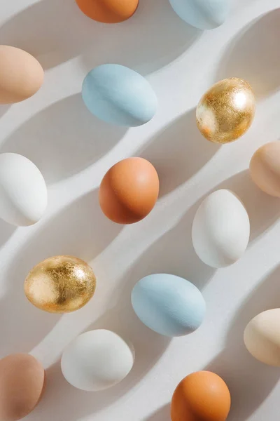 Natural Colored Eggs with morning sunlights. Stylish Compositions in pastel colors.  Easter concept.