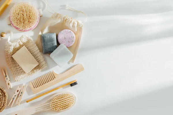 Set of Eco cosmetics products and tools. Soap, Shampoo Bottles, bamboo toothbrush, natural wooden brush. Zero waste, Plastic free. Sustainable lifestyle concept.