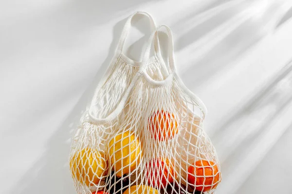 Cotton net bag with fruits. Sustainable lifestyle.  Eco friendly concept.