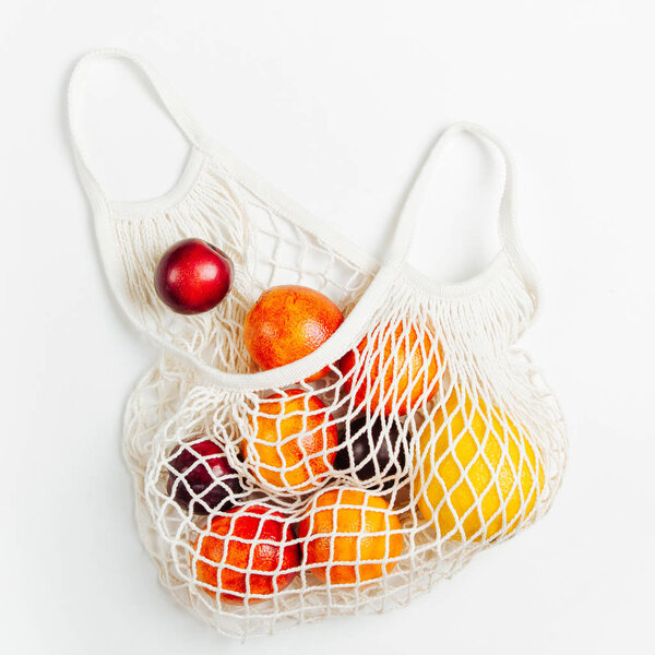 Cotton net bag with fruits. Sustainable lifestyle.  Eco friendly concept.