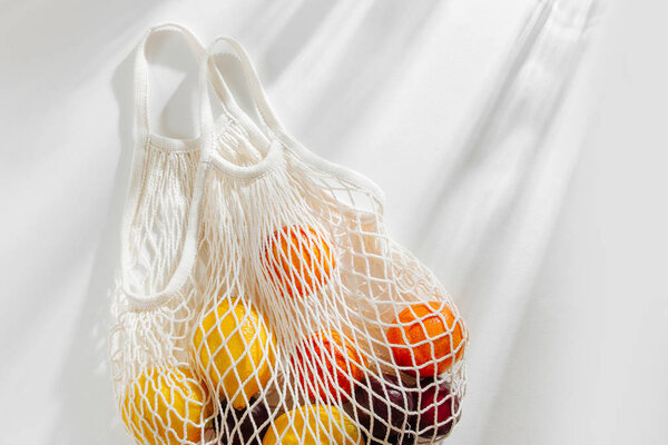 Cotton net bag with fruits. Sustainable lifestyle.  Eco friendly concept.