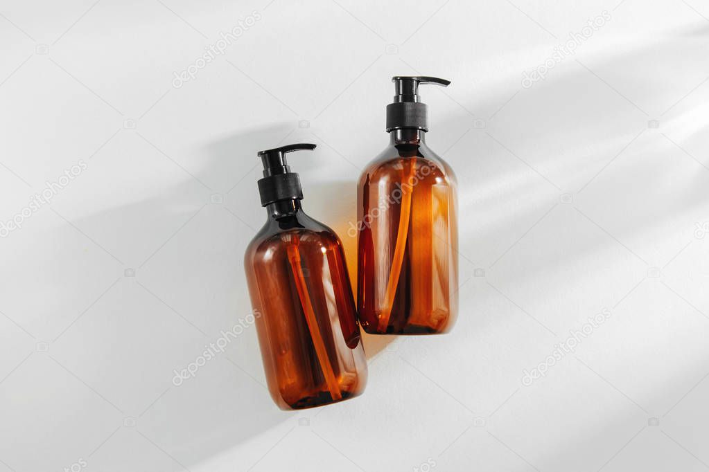 Transparent brown Bottles for Shampoo, Soap or other cosmetic on white background
