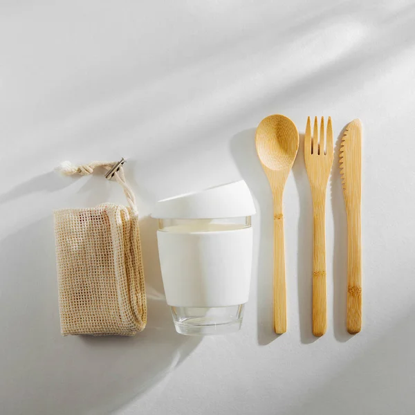 Eco friendly bamboo cutlery set and reusable coffee mug. Zero waste, plastic free concept.