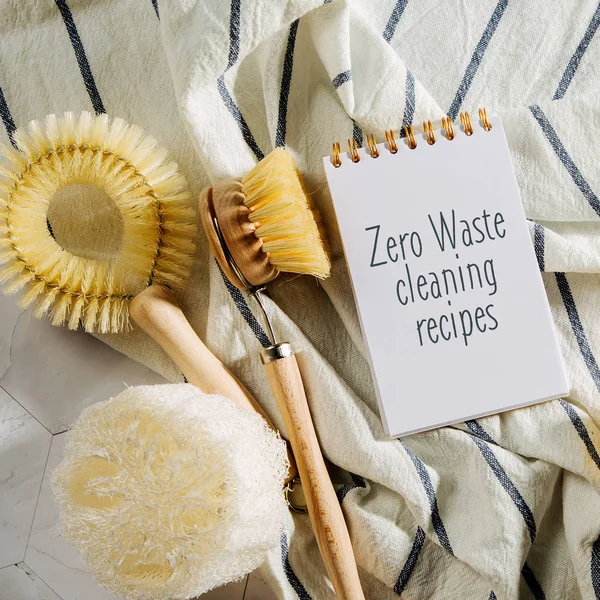 Natural cleaning products lemon, bamboo dish brushs with notebook. Zero Waste Cleaning Recipes