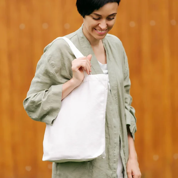 Woman holding canvas tote bag. Reusable eco bag. Eco friendly concept.