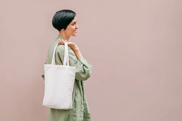 Woman holding canvas tote bag. Reusable eco bag. Eco friendly concept.