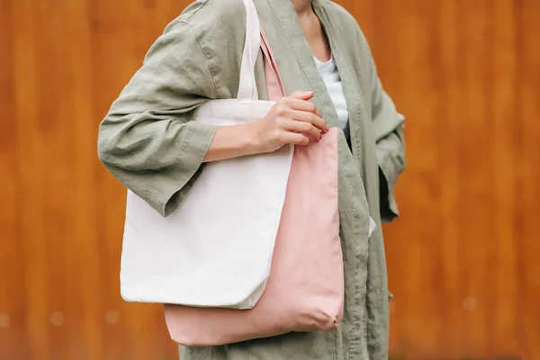 Woman holding canvas tote bag. Reusable eco bag. Eco friendly concept.