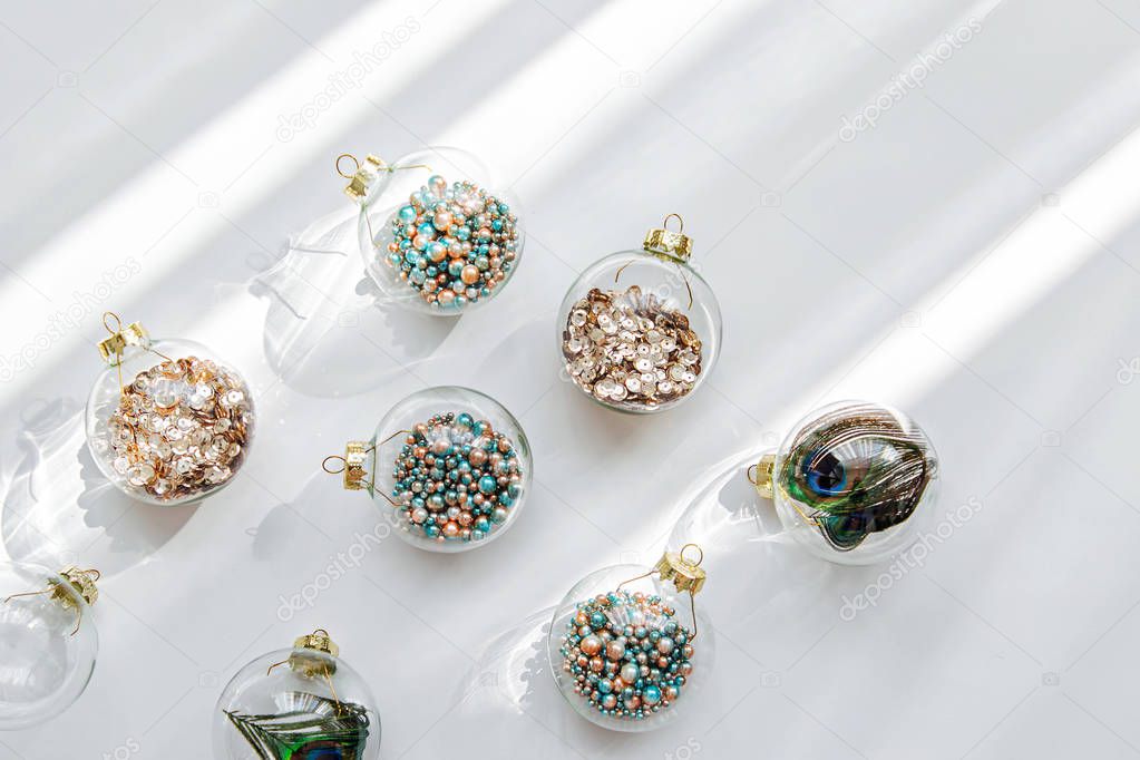 Holiday pattern. Christmas glass transparent ball with colorful sparkle confetti and decoration. Christmas concept 