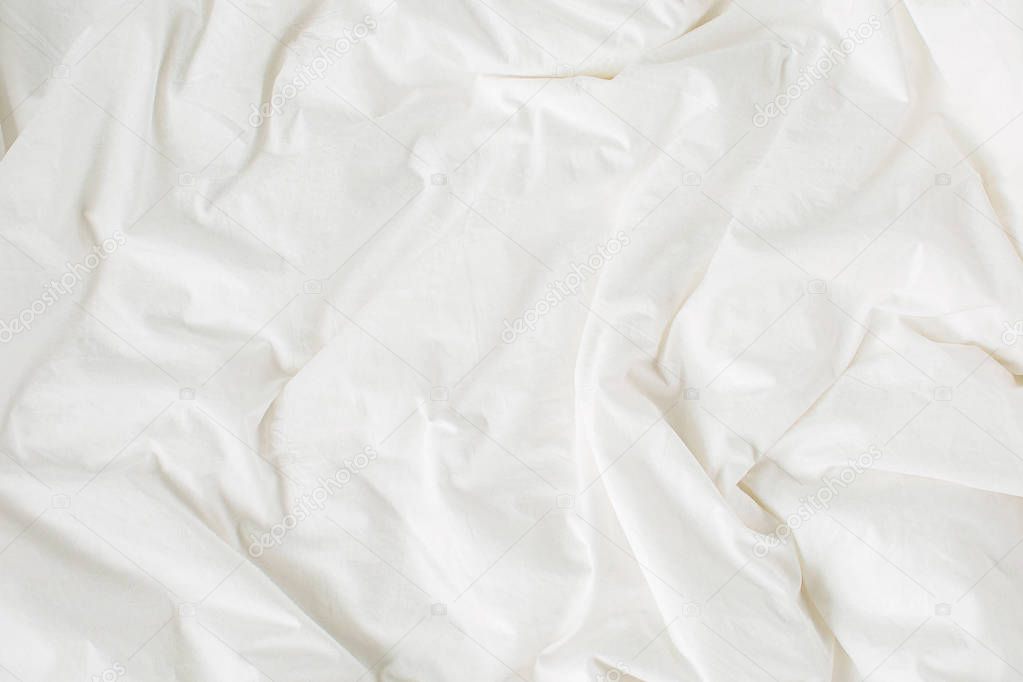 White bedding sheets. Cozy background. Flat lay, top view