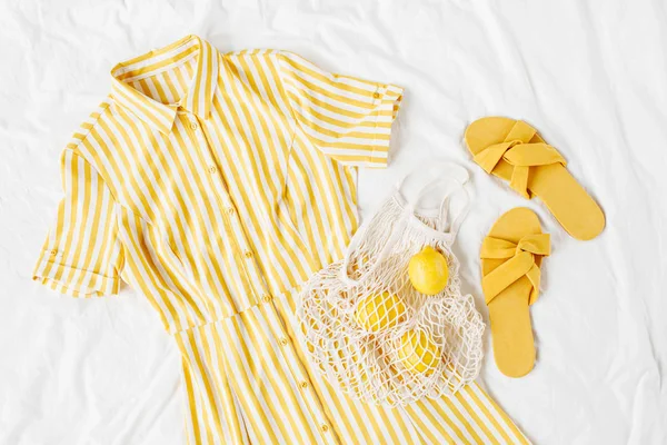 Κίτρινο Φόρεμα Ρίγες Οικολογική Τσάντα Και Παντόφλες Λευκό Κρεβάτι Κομψό — Φωτογραφία Αρχείου