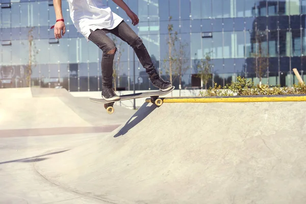 Skateboarder doing a trick in a skate park, practice freestyle extreme sport