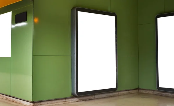 Empty white advertising urban billboard indoor in subway hall, vertical portrait, green walls