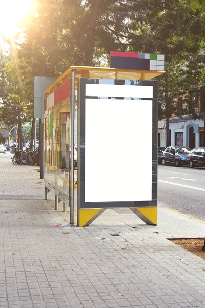 Vertical empty billboard placeholder template on the city bus stop, empty information banner template, space for mockup layout.