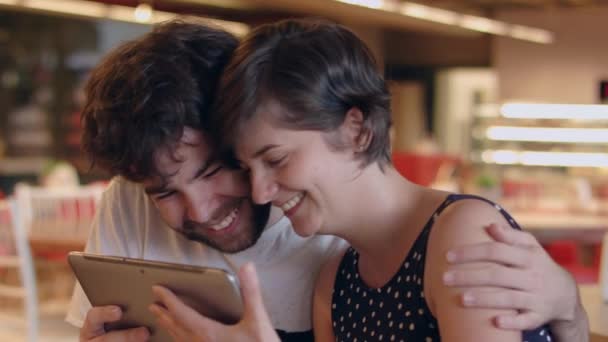 Young Couple Talks Some App Coffee Shop Looking Tablet — Stock Video