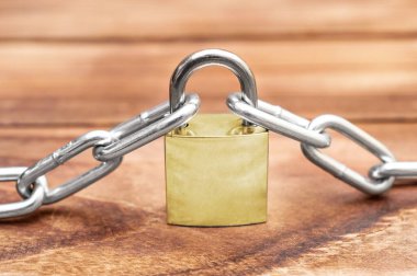 Ahşap masada zincirli asma kilit. Güvenlik kavramı.