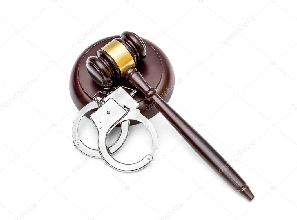 Gavel with stand and handcuffs on white background. Top view.