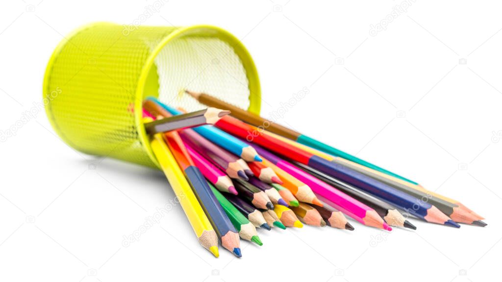 Colored pencils scattered from metal pencil holder on white background.