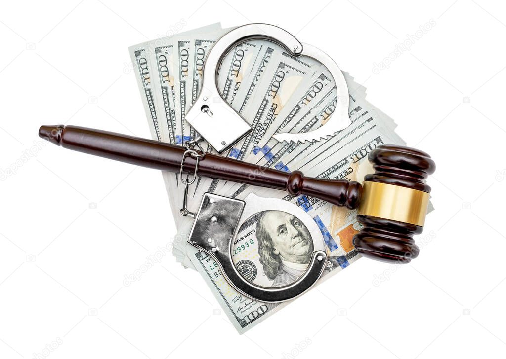 Judge's gavel with opened handcuffs and dollar bills on white. Top view.