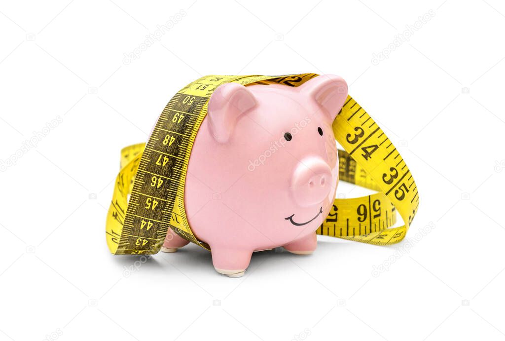 Piggy bank with measure tape on white background. 