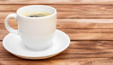 Tahta masada bir fincan kahve. Metin için boşluk.