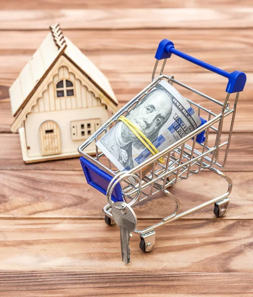 Shopping Cart Rolled Dollar Bills Model House Wooden Background — Stock Photo, Image