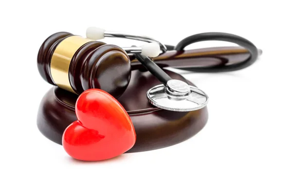 Gavel with red heart and stethoscope on white. Medical law.