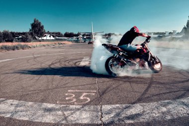 Moskova, Rusya - 13 Temmuz 2020: Moto binicisi motosikletini yakıyor. Motosiklet dublörü motosiklet gösterisi yapıyor. Motosikletli tehlikeli bir gösteri yapıyor.