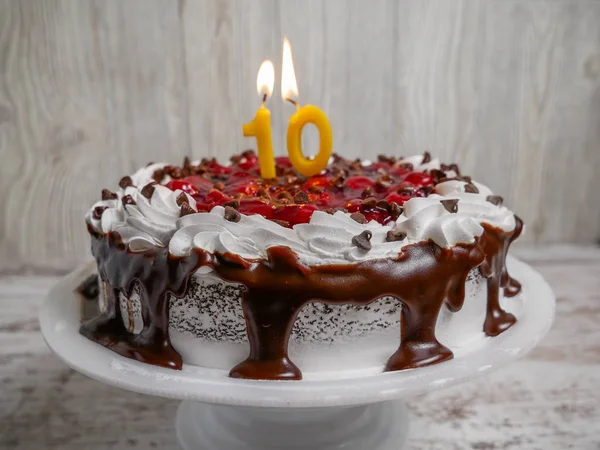Chocolate cherry cake with ten candle for celebration — Stock Photo, Image