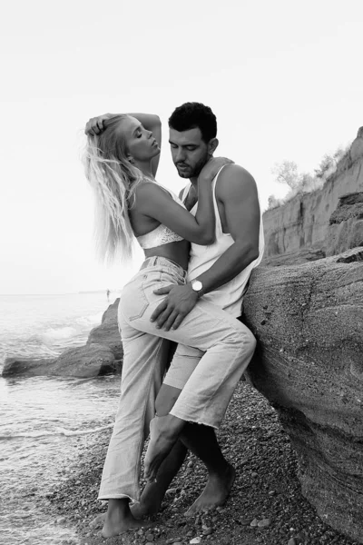 Frumos cuplu minunat purtând blugi, pozând la plaja de vară — Fotografie, imagine de stoc