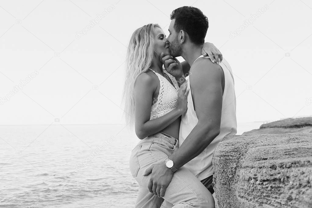 beautiful lovely couple wearing jeans,posing at summer beach