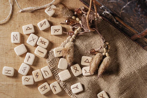 Handmade scandinavian wooden runes on a wooden vintage background. Concept of fortune telling and prediction of the future