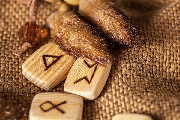 Handmade scandinavian wooden runes on a wooden vintage background. Concept of fortune telling and prediction of the future