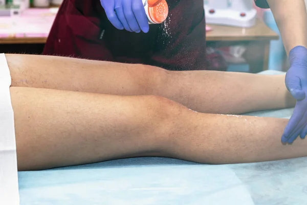 Preparation of skin for sugaring. The skin is treated with a powder